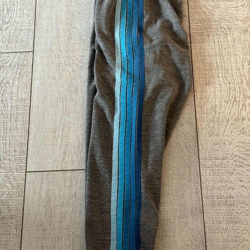 Aviator nation women’s sweatpants with colorful blue logo stripes on one leg